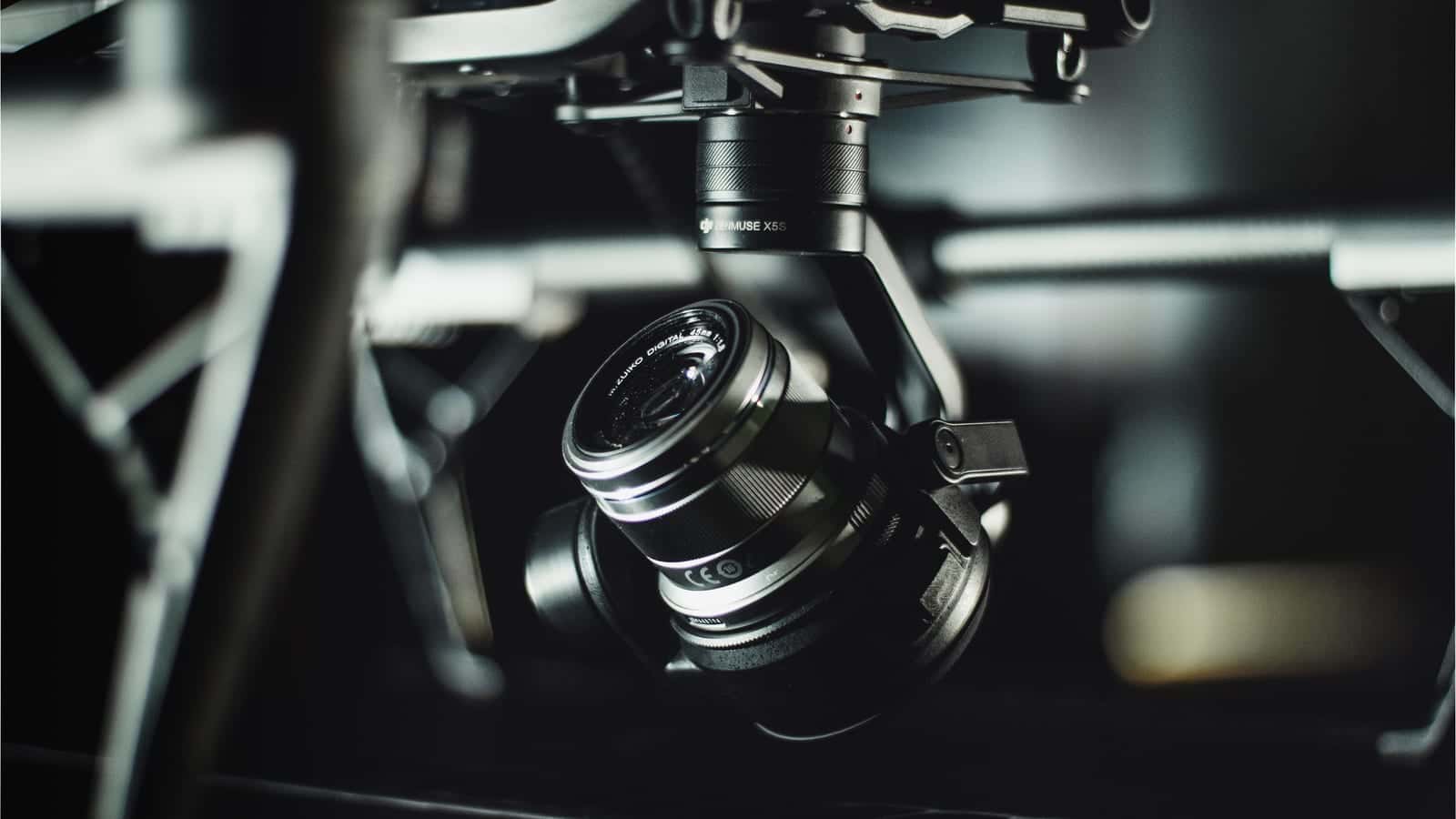 Close-up of a cinema camera and lens held in a drone gimbal